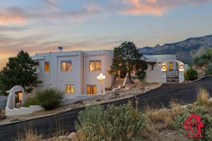 a house in the desert with a sunset at Elena's Sandia Sanctuary - An Irvie Home in Albuquerque