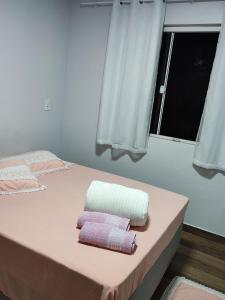 1 dormitorio con 2 camas y toallas. en Casa Silvano's, en Foz do Iguaçu