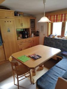 a kitchen with a wooden table and a dining room at Haus Maria in Patergassen