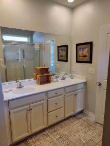 a bathroom with two sinks and a large mirror at Golf Resort, Beach, Entire House in Myrtle Beach
