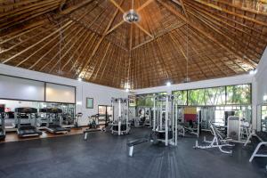 a gym with treadmills and exercise equipment in a building at Viva Maya by Wyndham, A Trademark All Inclusive Resort in Playa del Carmen