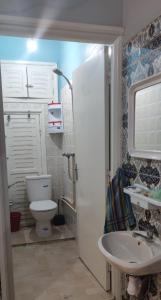 a small bathroom with a toilet and a sink at amine adnane in Safi