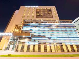 a building with the novation sign on the side of it at Novotel Lodz Centrum in Łódź