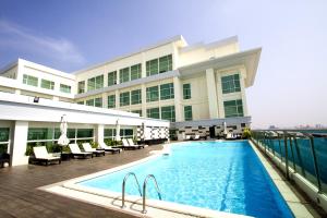 a hotel with a swimming pool and a building at Dara Airport Hotel in Phnom Penh