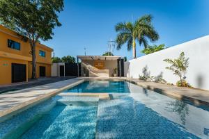 a swimming pool in the backyard of a house at Hotel MID Project in Mérida
