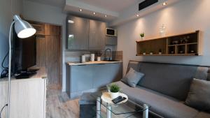 a living room with a couch and a kitchen at Barbara 12 in Ustroń