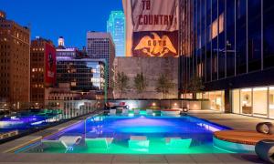 a large swimming pool in a city at night at Hilton Garden Inn Downtown Dallas in Dallas
