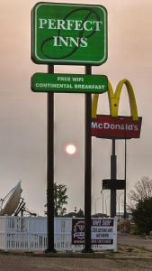 a sign for a fast food restaurant on a street at Perfect Inns & Suites in Weyburn