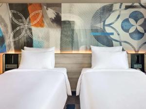 Postel nebo postele na pokoji v ubytování Novotel Suites Yogyakarta Malioboro