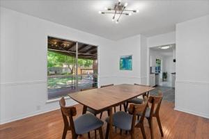 a dining room with a wooden table and chairs at Small Town, Big House - Sleeps 8! in Taylor