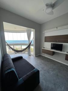 a bedroom with a bed and a view of the ocean at Lindo vista mar na Praia do Buracão - Rio Vermelho in Salvador