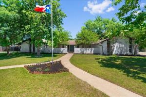 a flag on a pole in a yard at Small Town, Big House - Sleeps 8! in Taylor