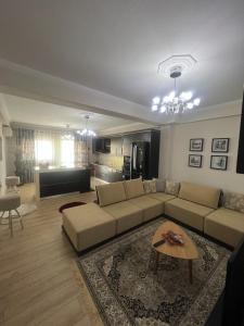 a living room with a couch and a table at Dream House Korça in Korçë