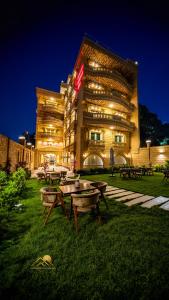 a building with picnic tables in front of it at night at Pyramids sunrise inn in Cairo