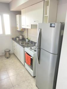 a kitchen with a stainless steel refrigerator and a stove at Altezza apartamento in San Francisco