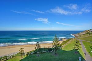 an aerial view of a beach and the ocean at 603 Newcastle Beachfront Apartment in Newcastle