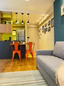 a living room with a couch and a table and chairs at FLAT EXCELSIOR- PRÓXIMO SHOPPING RIOMAR in Recife