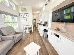 a kitchen and living room of a tiny house at Sun Outdoors - Myrtle Beach in Conway