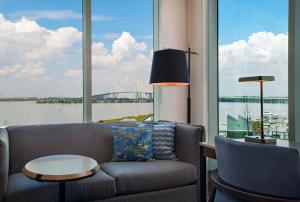a living room with a couch and a large window at Hyatt Regency Baytown-Houston in Baytown