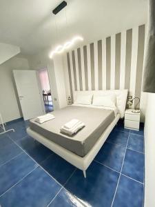 a bedroom with a large bed with blue tiles at Relais Galatea Airport Costa D'Amalfi in Montecorvino Pugliano