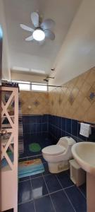 a bathroom with a toilet and a sink at Yethan house in Uvita