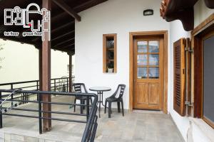 a patio with chairs and a table and a door at Great Villa Philipi in Krinídhes