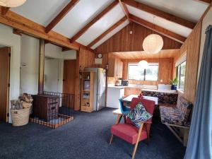 a living room with a kitchen and a dining room at Treetop Treasure - Hanmer Springs Holiday Home in Hanmer Springs