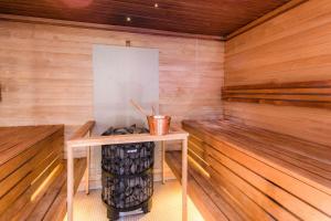 a sauna with a table and a bucket of logs at Park Inn by Radisson Central Tallinn in Tallinn