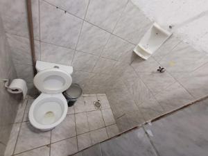 a bathroom with a white toilet in a stall at ADE águas claras 01 in Brasilia