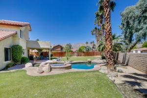 einen Hinterhof mit einem Pool und einer Palme in der Unterkunft Beautiful La Quinta Oasis with Pool and Spa! in La Quinta