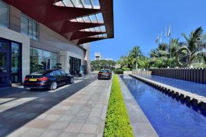 two cars parked in front of a building at Radisson Blu Hotel, Indore in Indore