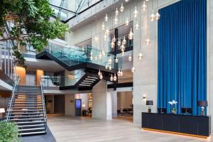 a view of the lobby of a building with a staircase at The Edwardian Manchester, A Radisson Collection Hotel in Manchester