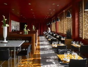 a row of tables in a restaurant with red walls at Radisson Blu Hotel, Liverpool in Liverpool