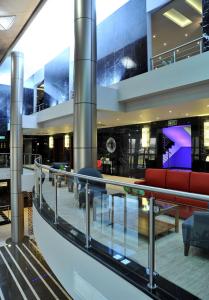 a lobby of a building with a red couch at Radisson Blu Hotel Lusaka in Lusaka
