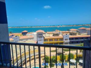 a balcony with a view of the beach and buildings at Porto marina in El Alamein