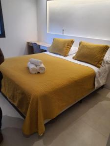 a bedroom with a bed with towels on it at Apart hotel plaza Elysées in Rio de Janeiro