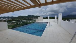 a swimming pool on the roof of a house at Lindo apartamento en Santa Marta, Rodadero, Gaira 503 in Santa Marta