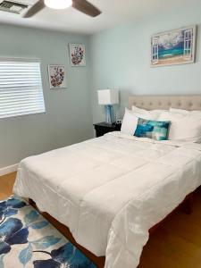 a bedroom with a large white bed with a ceiling at SeaSide Townhome, Spacious 2br 3bath Leeward Grace Bay, Providenciales, walk to beach in Providenciales
