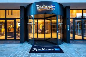 a facade of a building with revolving doors at Radisson Blu Hotel, Rouen Centre in Rouen