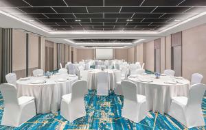 a conference room with white tables and white chairs at Park Inn By Radisson Bacolod in Bacolod