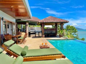 a villa with a swimming pool with a table and chairs at Baan Talay Sai Villa - Panoramic Views 300m to Beach in Koh Samui