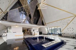 a large room with a fountain in the middle of a building at Radisson Blu Hotel Riyadh Qurtuba in Riyadh