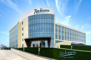 a building with a sign on top of it at Radisson Hotel Bareilly Airport in Bareilly