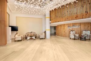 a large room with chairs and a wall with lights at Radisson Hotel Bareilly Airport in Bareilly