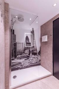 a bathroom with a shower with a picture of the city at Radisson RED London Heathrow in Harmondsworth