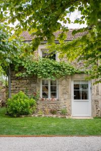 a brick house with a white door and windows at A PAS DE LOUP, Maison de charme sur domaine viticole in Chaux