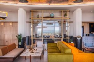 a living room with a couch and a table at Radisson Blu Grand Hotel & Spa, Malo-Les-Bains in Dunkerque