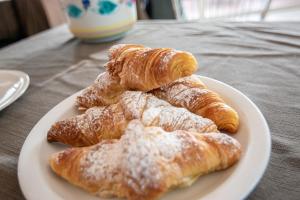 a white plate of pastries on a table at Hotel Lily in Rimini