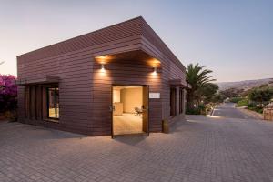 a small building with a door on a brick road at Radisson Blu Resort Taghazout Bay Surf Village in Taghazout