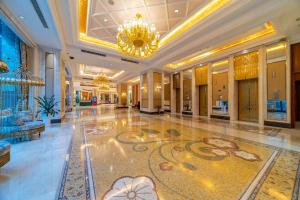 a lobby of a hotel with a chandelier and a floor at Ramada Yichang Hotel in Yichang